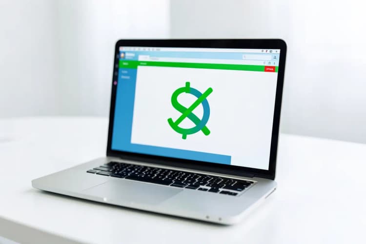 Um computador portátil aberto mostrando uma interface de criação de páginas, com um ícone de cifrão riscado.
